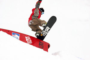 Acrobatic snowboarder in Park Sulayr in Sierra Nevada, Granada